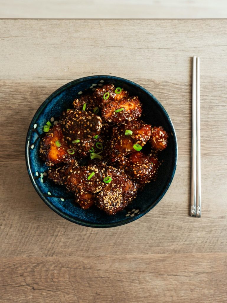 a-blue-bowl-filled-with-meat-and-vegetables-hcobrgaalp8